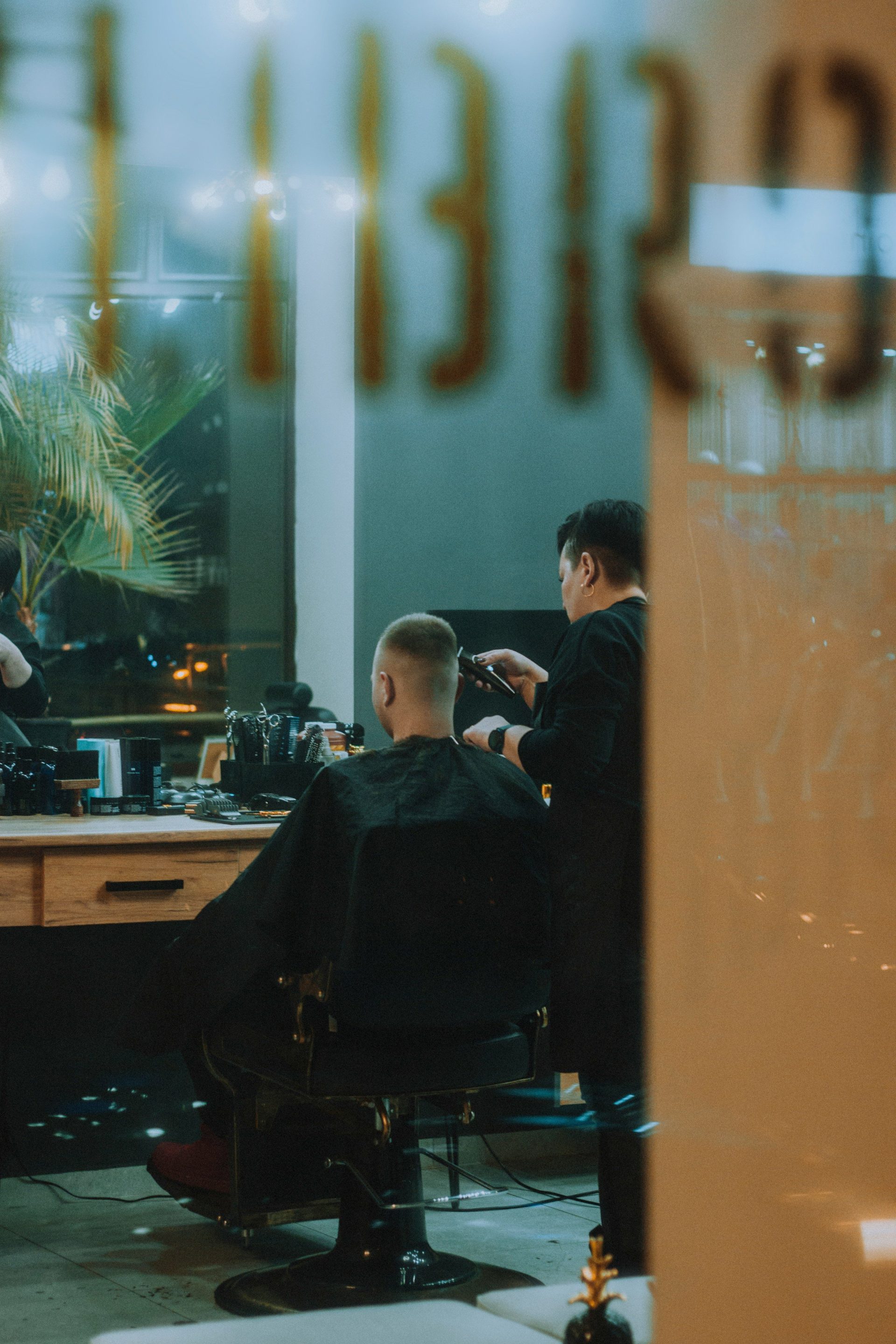 a man getting his hair cut in a barber shop